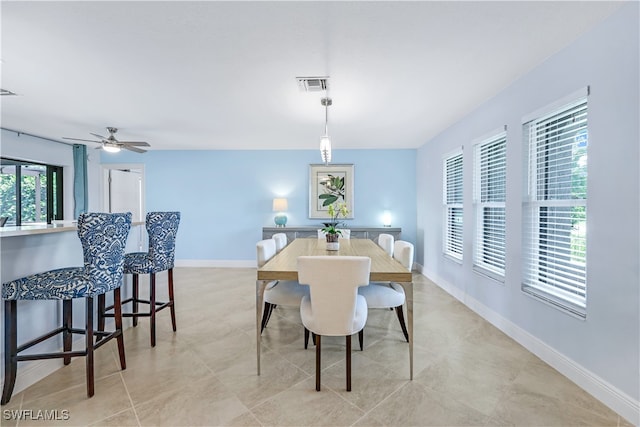 dining space with ceiling fan and light tile patterned floors