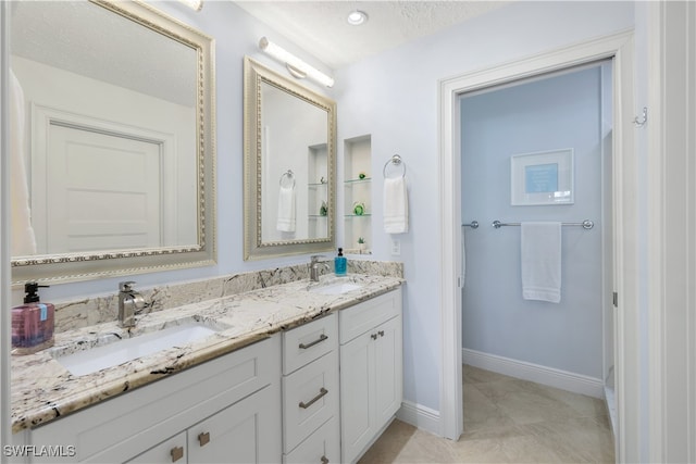 bathroom with vanity and a textured ceiling