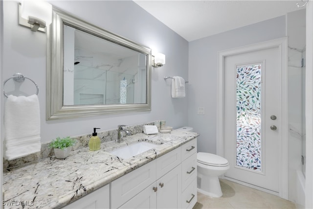 bathroom featuring vanity, toilet, and a shower