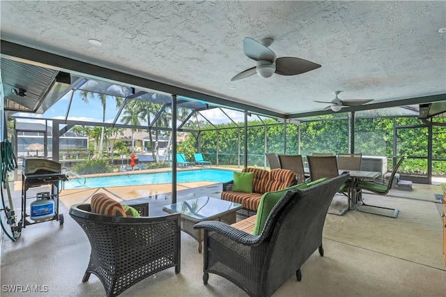 exterior space featuring outdoor lounge area, ceiling fan, area for grilling, and glass enclosure