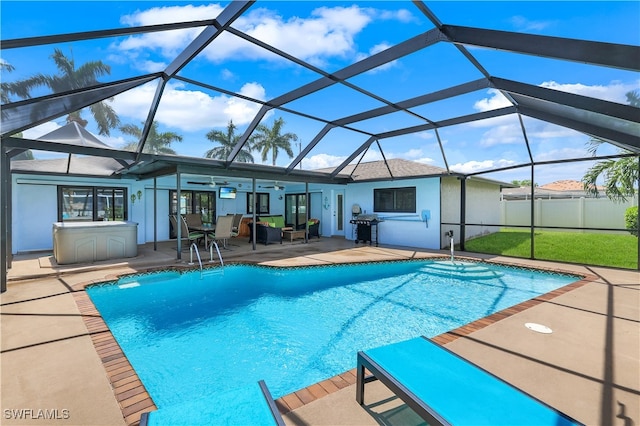 view of swimming pool featuring glass enclosure, ceiling fan, a patio, and grilling area