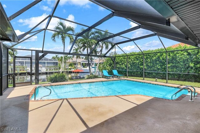 view of pool featuring a water view, a patio area, and a lanai