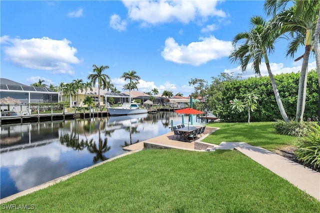 dock area with a water view and a lawn