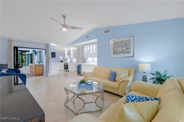 living room with ceiling fan, wine cooler, and vaulted ceiling