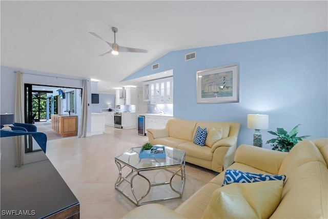 living room with vaulted ceiling, sink, beverage cooler, and ceiling fan