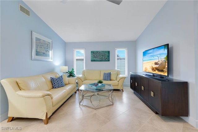 tiled living room featuring vaulted ceiling