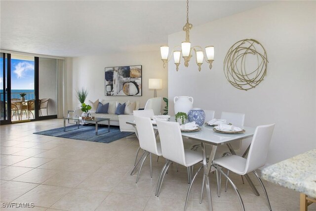 dining room with a water view, floor to ceiling windows, and a notable chandelier