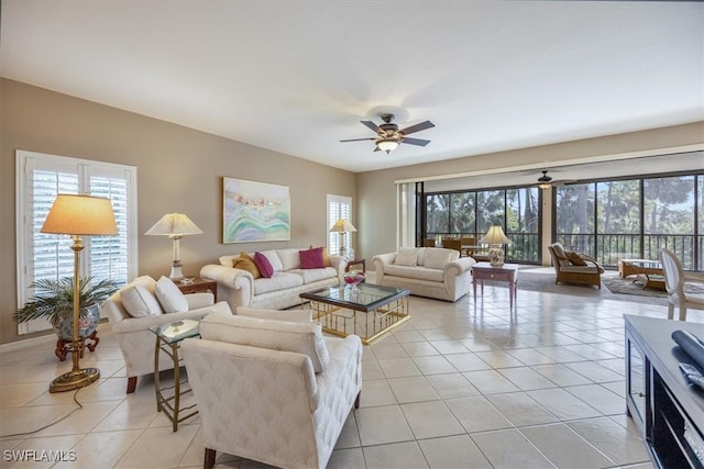 tiled living room with ceiling fan and a healthy amount of sunlight