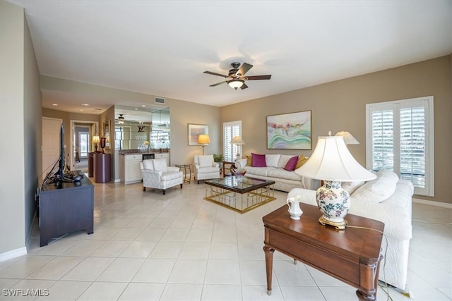 living room featuring ceiling fan and light tile patterned flooring