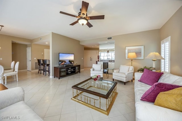 tiled living room featuring ceiling fan