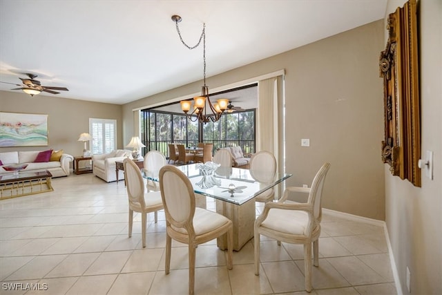 dining room featuring ceiling fan with notable chandelier and light tile patterned floors