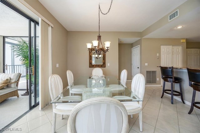 tiled dining room featuring a chandelier