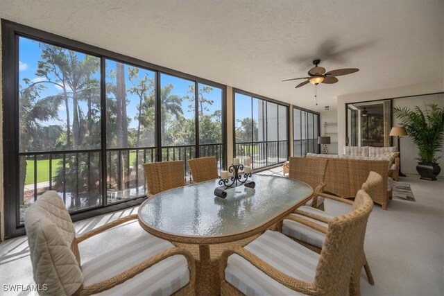 sunroom featuring a wealth of natural light and ceiling fan