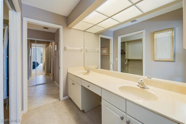 bathroom featuring tile patterned flooring and vanity