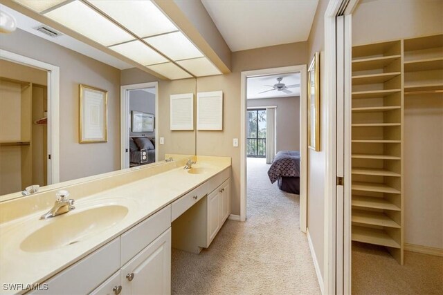 bathroom with ceiling fan and vanity