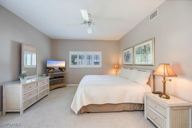 carpeted bedroom featuring multiple windows and ceiling fan