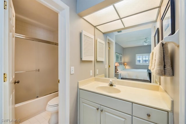 full bathroom with vanity, ceiling fan, enclosed tub / shower combo, tile patterned flooring, and toilet