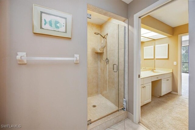 bathroom featuring tile patterned floors, vanity, and an enclosed shower