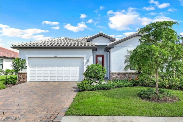 view of front of house with a garage and a front lawn