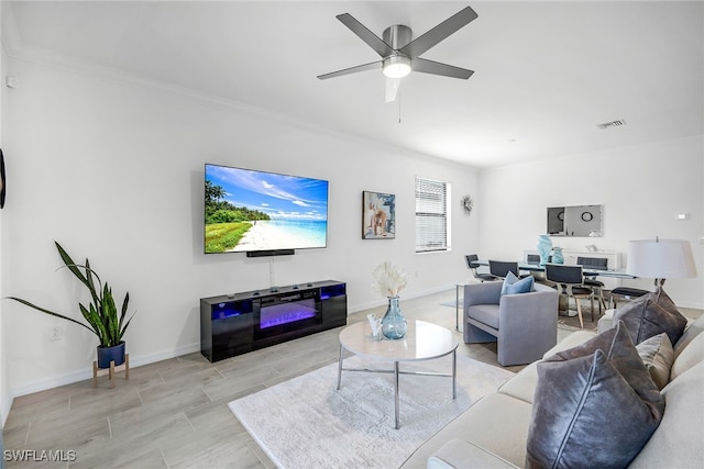 living room featuring crown molding and ceiling fan