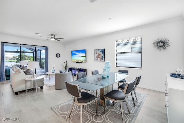 dining space featuring ornamental molding and ceiling fan