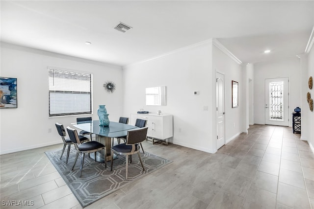 dining space featuring crown molding and a wealth of natural light