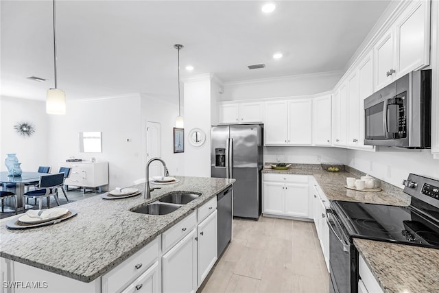 kitchen featuring white cabinetry, stainless steel appliances, light stone counters, sink, and a center island with sink