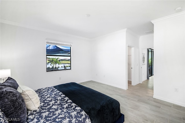 bedroom featuring light wood-type flooring and ornamental molding