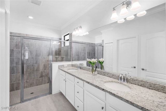 bathroom with crown molding, vanity, an enclosed shower, and tile patterned floors