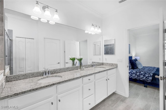 bathroom with ornamental molding and vanity