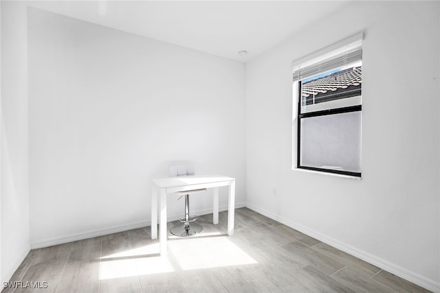 empty room with light hardwood / wood-style flooring