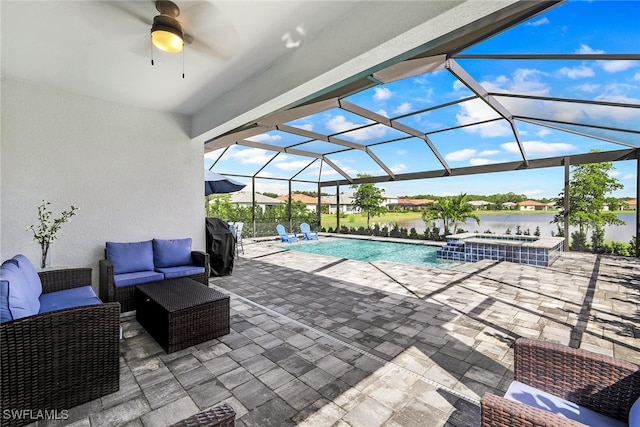 view of pool with a patio, pool water feature, an outdoor living space, ceiling fan, and a water view