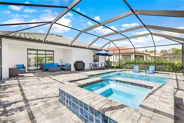 view of pool featuring glass enclosure, a patio area, outdoor lounge area, and an in ground hot tub