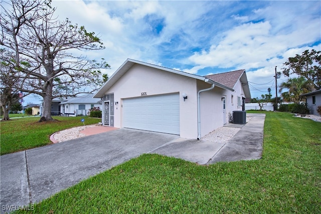 view of side of property with a lawn, central AC unit, and a garage