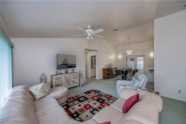 carpeted living room with lofted ceiling and ceiling fan with notable chandelier