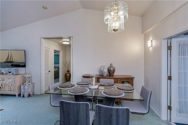 carpeted dining room featuring lofted ceiling