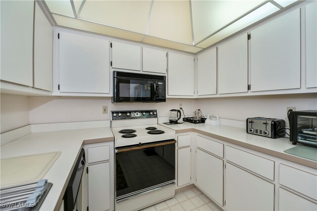 kitchen with white electric range and white cabinetry