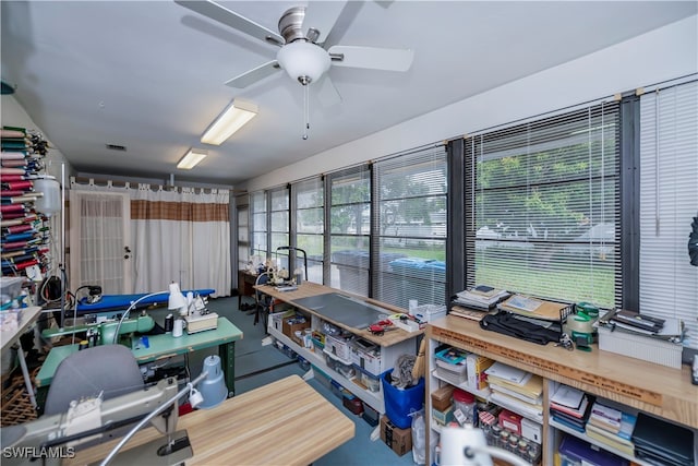 carpeted home office featuring ceiling fan and a wealth of natural light