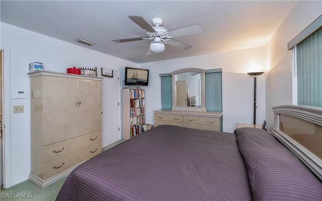 bedroom with light colored carpet and ceiling fan