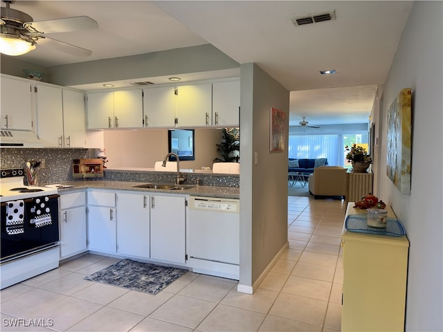 kitchen with electric range, sink, light tile patterned floors, white dishwasher, and white cabinets