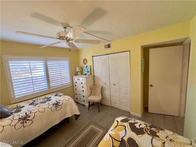 bedroom with ceiling fan, a closet, and dark wood-type flooring