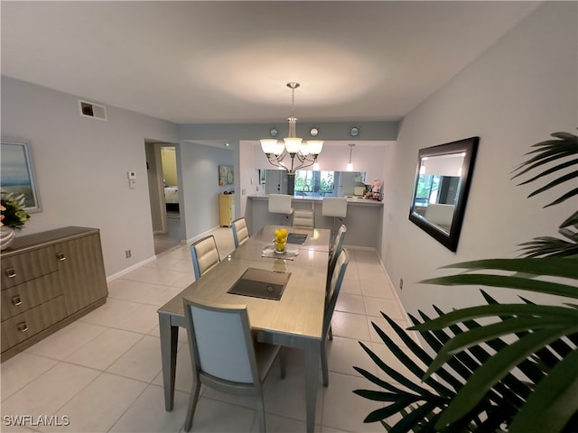 dining room featuring light tile patterned floors and an inviting chandelier