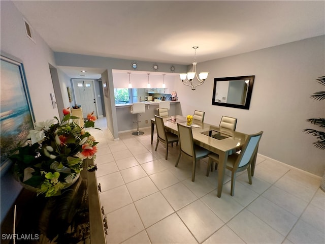 tiled dining area featuring a chandelier