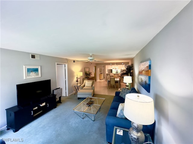 living room featuring carpet and ceiling fan