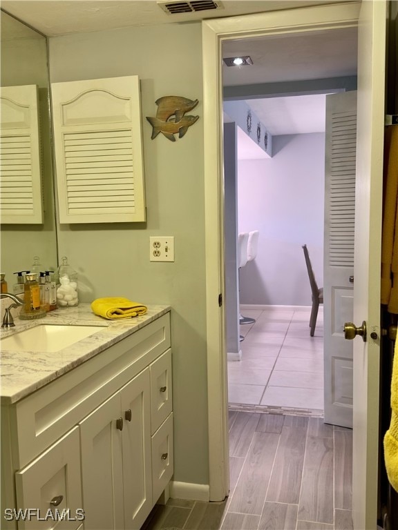 bathroom with hardwood / wood-style floors and vanity