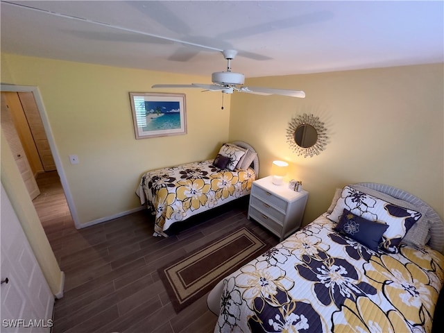 bedroom with dark hardwood / wood-style flooring and ceiling fan