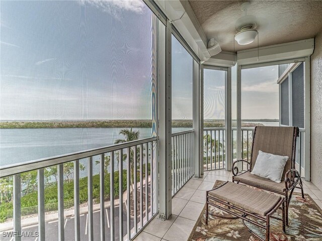 sunroom / solarium featuring a water view