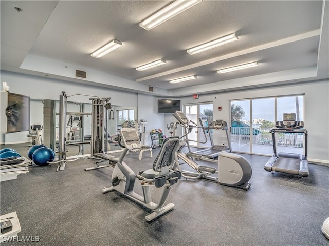 gym with a textured ceiling