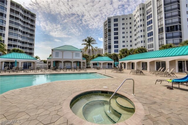 view of pool featuring a patio area and a hot tub