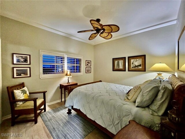 bedroom with ceiling fan and ornamental molding